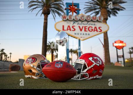 San Francisco 49ers, Kansas Chiefs helmets and the Vince Lombardi trophy at the Welcome to Fabulous Las Vegas sign, Tuesday, Jan. 30, 2024, in Las Veg Stock Photo