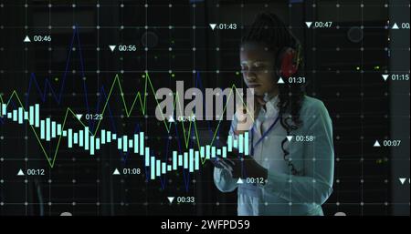 Image of data processing over african america nwoman using headphones in server room Stock Photo