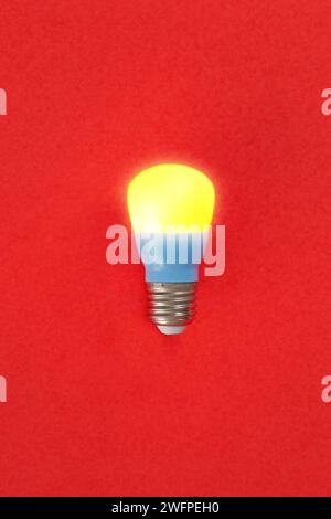 An interesting color composition between burning light bulbs and a red background Stock Photo