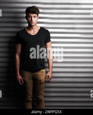 Fashion, style and portrait with man on wall background for student, trendy and casual. Cool, mockup and handsome with young male person in urban Stock Photo