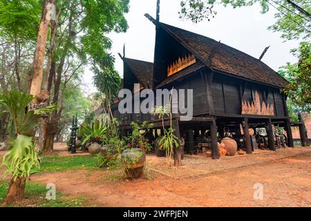 Chiang Rai,Thailand-March 31 2023:Within extensive,exquisite grounds,a collection of dark and black wood buildings,and artefacts,featuring works by Th Stock Photo