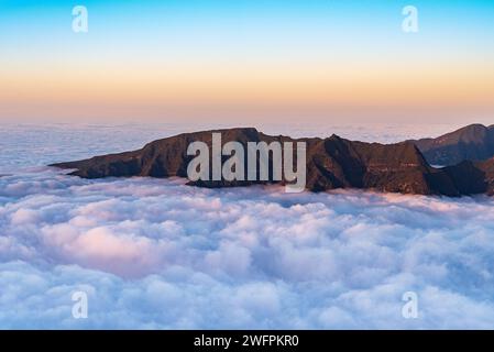 Hills with steep slopes above clouds in Madeira during sunset - view from Bica da Cana hill summit Stock Photo