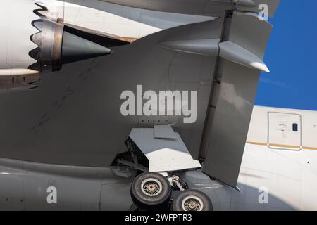 Close up photo of a Saudi Arabian Airlines Boeing 787-10 Dreamliner, reg HZ-AR25 detailing part of the engine, undercarriage, wing, flaps and fuselage Stock Photo