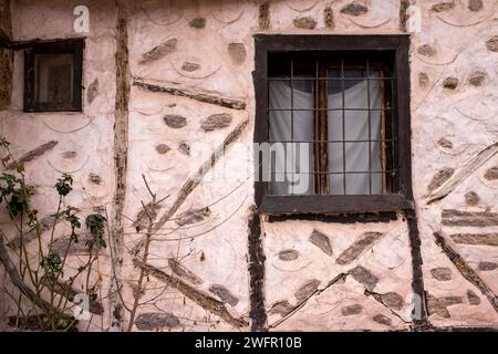 Window and wall of authentic stone house Stock Photo
