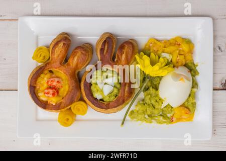 Puff pastry vol-au-vents shaped like an easter bunny filled with mango and avocado mousse Stock Photo