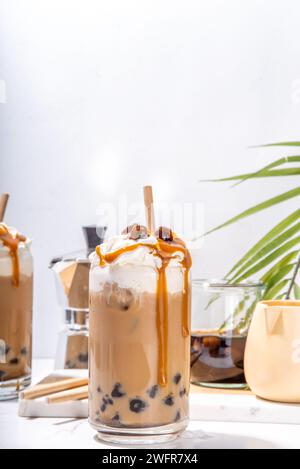 Tapioca boba balls coffee frappe, asian trendy cold coffee drink with tapioca balls and whipped coconut cream and caramel sauce Stock Photo