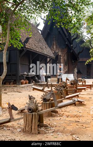Chiang Rai,Thailand-March 31 2023:Within extensive,exquisite grounds,a collection of dark and black wood structures,and artefacts,featuring works by T Stock Photo