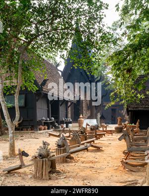 Chiang Rai,Thailand-March 31 2023:Within extensive,exquisite grounds,a collection of dark and black wood structures,and artefacts,featuring works by T Stock Photo