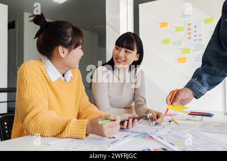 team of UI UX web designer are working together to develop mobile responsive websites with UI UX front end designer previews Stock Photo