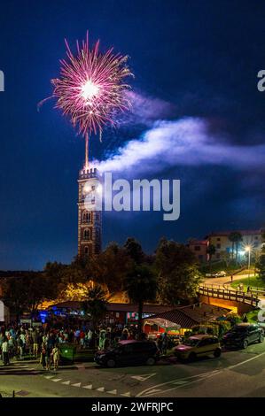 Fireworks in Cassacco. Celebrations between the cathedral and the ancient bell tower Stock Photo