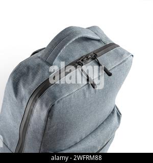 Top view of a blue backpack with a large zippered compartment and a top carrying handle isolated on white. Stock Photo