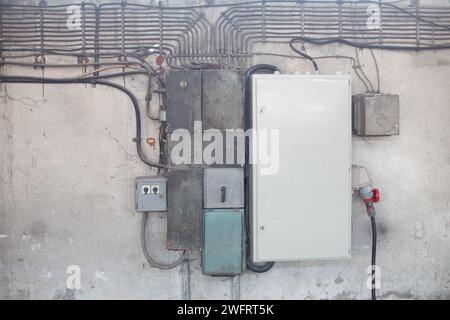 old electrical wires and transformers on the wall Stock Photo