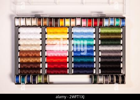 many colorful sewing threads on spools Stock Photo