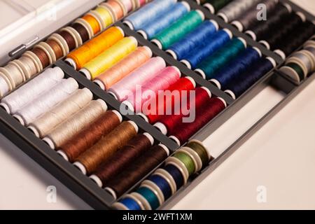 many colorful sewing threads on spools Stock Photo