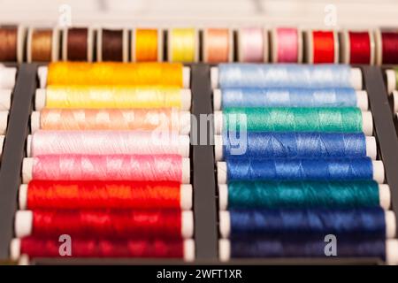 many colorful sewing threads on spools Stock Photo