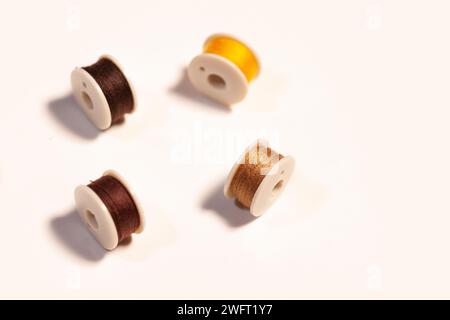 colorful sewing threads on bobbins isolated on white Stock Photo