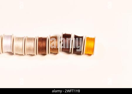 colorful sewing threads on bobbins isolated on white Stock Photo