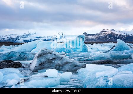 A stack of ice pieces floating in water Stock Photo