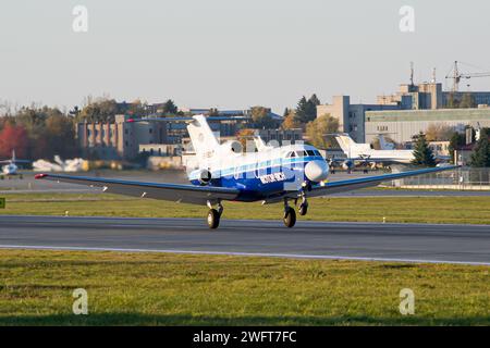 Ukrainian airline's Motor Sich Yakovlev Yak-40 taking off from Lviv during golden hour Stock Photo