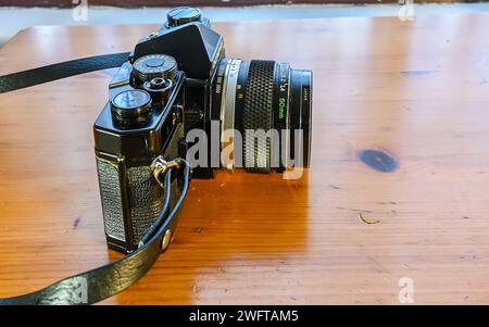 A Retro vintage Olympus OM-1 35mm single lens reflex film camera and 50mm 1.8 lens with closeup with selective focus Stock Photo