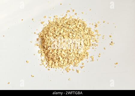 A pile of instant oatmeal lies on a white background. Stock Photo