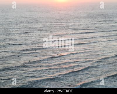 Surfers in the water at Ribeira d'Ilhas Beach Ericeira Portugal Stock Photo