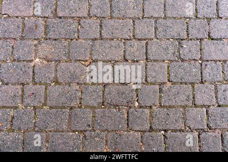 Texture of footpath pavement as seen from above. Old irregular stones being used. Stock Photo