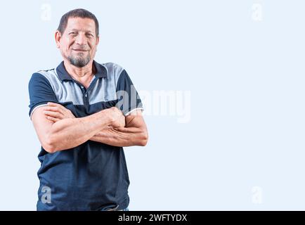 Portrait of smiling senior man with arms crossed isolated. Smiling latin old man with arms crossed, casual on isolated background Stock Photo