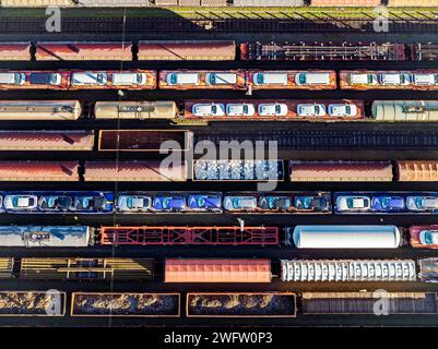 Deutsche Bahn AG marshalling yard. Many goods trains are parked on the tracks with tank wagons, car transporters and other wagons, companies Stock Photo