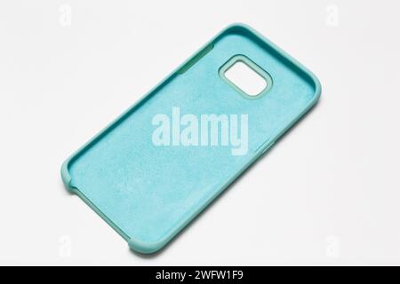 Beautiful soft pastel mint color mobile phone case isolated on white background. Stock Photo