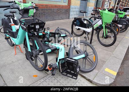 Tier and Lime  e-Bike Dockless Bicycle Hire System on Pavement  Chelsea London England Stock Photo