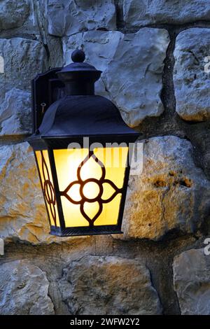 Streetlight lantern on stone wall Stock Photo