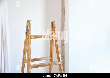 close-up of a wooden ladder and a wall repairing background Stock Photo