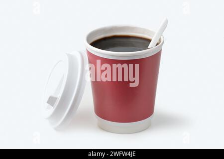 Disposable cup of coffee with a plastic spoon, isolated on white Stock Photo