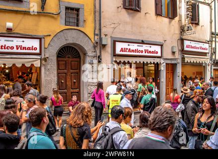 Crowds of people queueing outside All’Antico Vinaio , a well known Italian panini and sandwich shop on Via dei Neri, Florence, Italy Stock Photo