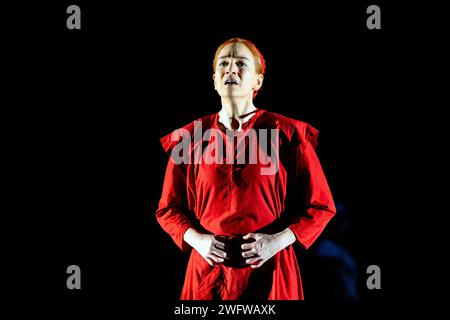 Kate Lindsey (Offred) in THE HANDMAID'S TALE at English National Opera (ENO), London Coliseum, London WC2  01/02/2024  music: Poul Ruders  libretto: Paul Bentley after the novel by Margaret Atwood  conductor: Joana Carneiro  design: Annemarie Woods  video design: Akhila Krishnan  original lighting: Paule Constable  original movement & intimacy coordinator: Imogen Knight  director: Annilese Miskimmon Stock Photo