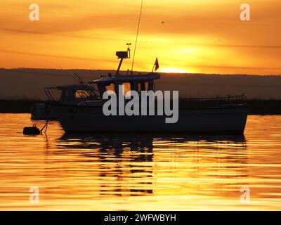 Queenborough, Kent, UK. 1st Feb, 2024. UK Weather: stunning Saharan dust sunset in Queenborough Harbour, Kent this evening. Credit: James Bell/Alamy Live News Stock Photo