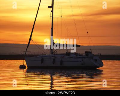 Queenborough, Kent, UK. 1st Feb, 2024. UK Weather: stunning Saharan dust sunset in Queenborough Harbour, Kent this evening. Credit: James Bell/Alamy Live News Stock Photo