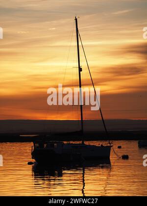 Queenborough, Kent, UK. 1st Feb, 2024. UK Weather: stunning Saharan dust sunset in Queenborough Harbour, Kent this evening. Credit: James Bell/Alamy Live News Stock Photo