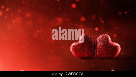 Background two red glitter hearts on red gradient background with flying particles. Front view. Stock Photo