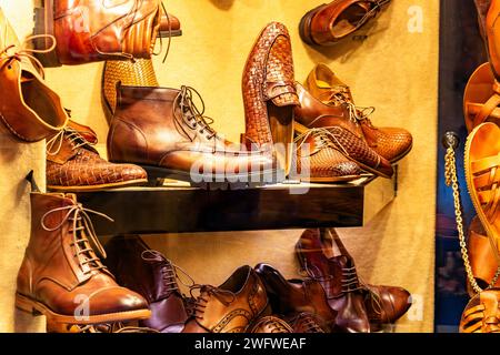 A selection of brown shoes and boots in a cobblers shop window on Via de' Guicciardini in the Oltrano district of Florence, Italy Stock Photo