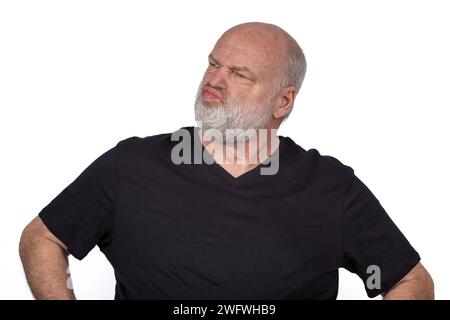 Suspicious Middle-Aged Man in Black T-Shirt - Stylish Portrait on White Background Stock Photo
