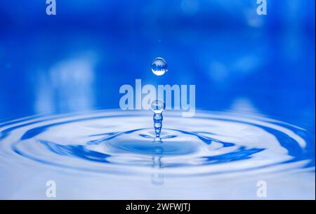a drop of water jumps upwards Stock Photo