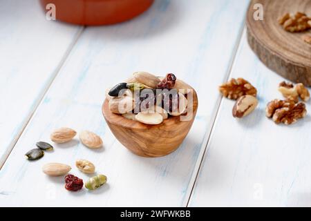 Various of berry, nuts and seeds in wooden bowl on a light wooden table. Stock Photo
