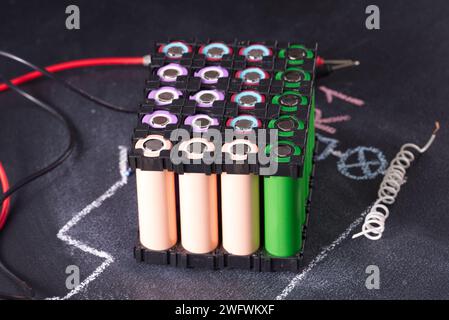 Lithium battery pack in black plastic holder dark background. Stock Photo