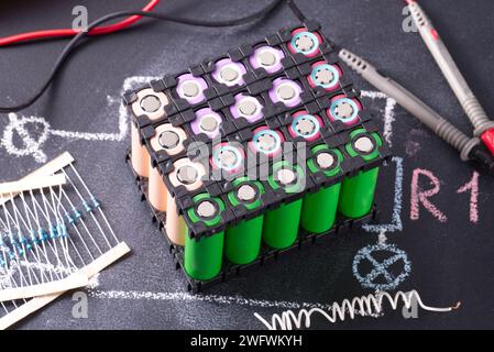 Lithium battery pack in black plastic holder dark background. Stock Photo