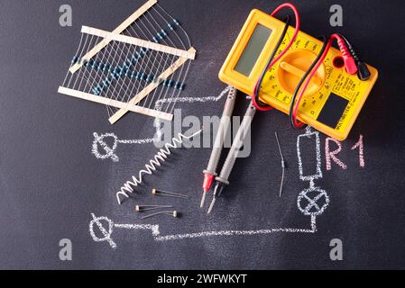Electronic parts and multimeter dark background. Stock Photo