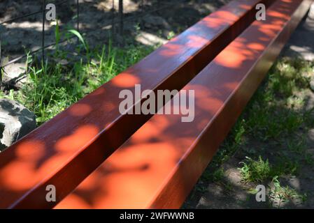 Building materials, equipment for construction and repair works. Long, thick, metallic profile covered with fresh brown fresh paint. Building profiles Stock Photo