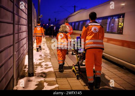 Dachau, Germany. 20th Jan, 2024. Rescue workers from the Bavarian Red Cross push a stretcher across a platform at Dachau station to a carriage of a Deutsche Bahn ICE train. Credit: Matthias Balk/dpa/Alamy Live News Stock Photo
