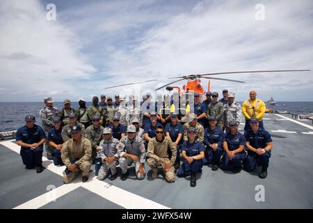 notReleased Sailors assigned to U.S. Coast Guard Cutter Munro (WMSL 755) pose for a group photo with sailors from the Thailand Maritime Enforcement Command Center during an at-sea engagement Sept. 1, 2023, in the South China Sea. Munro is deployed to the Indo-Pacific to advance relationships with ally and partner nations to build a more stable, free, open and resilient region with unrestricted, lawful access to the maritime commons. Stock Photo